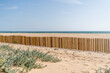 Sand beach with sea behind, dune fencing in wood, dune construction and strengthening 
