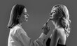 © Yevhen - Backstage makeup work in close-up. Make up artist doing professional make up of young woman. Applying tone to skin. Hand of visagiste, painting cosmetics beauty model girl. Black and white