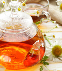 Poster - tea in a glass teapot with chamomile relax