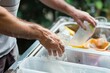 man rinsing out food containers before recycling