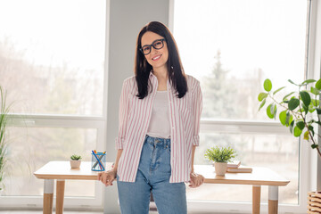 Wall Mural - Photo of confident nice positive girl entrepreneur posing desktop bright modern office building inside