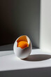 © ADDICTIVE STOCK - Cracked egg with yolk on minimalist background Generative AI image