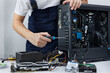 © Artem Zakharov - Closeup computer technician holding a screwdriver and repairing a pc.