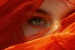 Enigmatic Woman with Mesmerizing Gaze, Orange Veil Portraiture, Perfect for Beauty and Fashion Themes. Hypnotic Eyes Peeking Through Orange Fabric