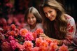 Mother and daughter planting bright and colorful flowers in their sunny home garden