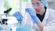 © Supapich - Woman research scientist biology chemistry medicine pouring liquid from beaker to test tube indoor science laboratory room, adult female person blue glove work discovery experiment medical chemist