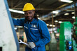 © KANGWANS - Black male mechanical engineer working at metal lathe factory Machine lathe operating engineer African American people.