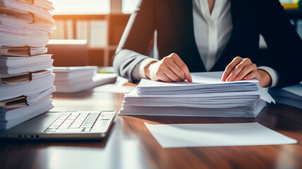 Wall Mural - business woman holding a stack of paper documents