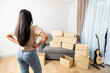 © virojt - young woman with boxes, Moving to a new home.