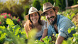 Smiling young couple cultivating in the vegetable garden