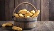 Bananas in a wooden bucket. On a wooden background