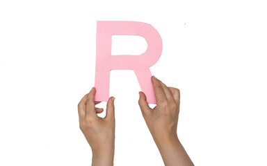 closeup hand holding paper letter R  isolated on white