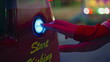 © stockbusters - Hand pushing start button at arcade game machine closeup. Funfair girl playing