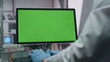 © stockbusters - Doctor typing green screen computer in modern advanced laboratory close up.