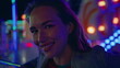 © stockbusters - Smiling girl posing neon amusement park closeup. Happy teen enjoying weekend