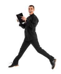 Wall Mural - Young priest with Holy Bible jumping on white background