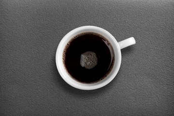 Canvas Print - White cup for morning coffee on desk background,