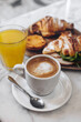 Coffee break with meia de leite - portuguese coffee with milk, pastel de nata, croissants and fresh orange juice.
