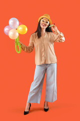 Poster - Happy young woman in costume and carnival mask with bouquet made from balloons on orange background