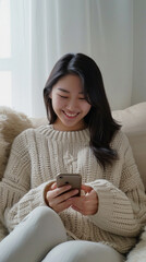 Woman use of smart phone in the living room at home, asian