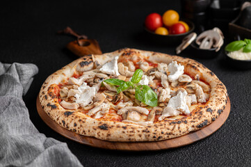 Wall Mural - a pizza with mushrooms and herbs on a wooden cutting board