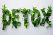 Detox word from fresh green leaves  on white background 