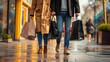 Cropped image of young couple walking with shopping bags in the city