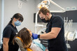 © RomanR - dentist and his assistant conduct a thorough examination and treatment of the patient.