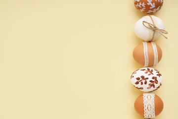 Wall Mural - Composition with decorated Easter eggs on beige background