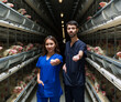 Egg factory. Vets handing eggs. Male and female veterinarians at work on a chicken farm.