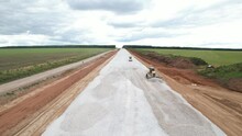 A Bulldozer And A Road Roller Are Laying Rubble On A New Road Before Asphalting. Road Construction Works, Aerial View. 
