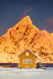 Fototapeta Na ścianę - Lofoten islands beautiful nature sunset landscape in Norway and fishing town with scenic yellow rorbu house of Sakrisoy, Reine