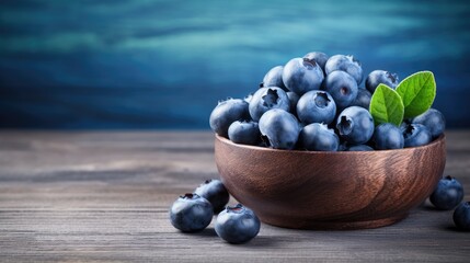 Wall Mural - Ripe Blueberries in a Rustic Bowl on a Blue Wooden Background with Freshness and Nature Concept