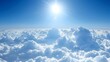 Breathtaking view of sun above clouds in a clear blue sky