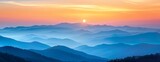 Fototapeta Na ścianę - Panoramic view of layered mountains under sunset, gradient of blue to orange hues in sky
