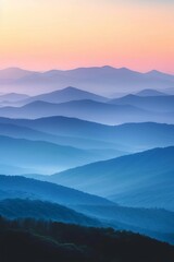 Wall Mural - Majestic mountain landscape at sunrise, rolling hills in shades of blue and orange skies