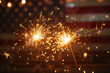 © Dennis - Sparklers in front of an American Flag, Independence Day celebration concept