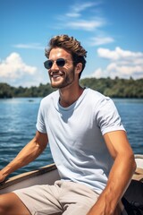 Sticker - A young man in a blank white t-shirt, enjoying a breezy boat ride on a clear blue lake