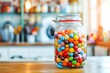 sweets in a glass jar on the table against the background of a blurred image of the kitchen 