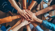© nettspring - Employees join hands in a circle, hands piled symbolizing unity, collaboration, and the power of corporate teamwork