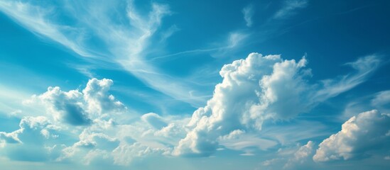 Wall Mural - a picturesque natural landscape featuring a bright blue sky filled with fluffy white cumulus clouds,