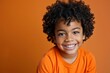 Portrait of a mixed race boy with a bright smile Showcasing joy and innocence in a studio setting