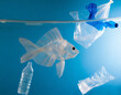 Ocean Pollution Concept Art : floating fish made of transparent plastic with PET bottles and plastic bags