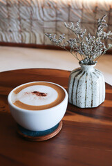 Wall Mural - hot coffee, cappuccino coffee or latte coffee or flat white or mocha coffee and caspia flower in a vase