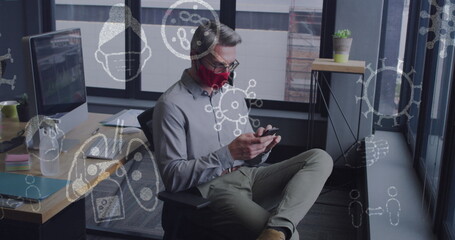 Sticker - Image of virus icons over caucasian businessman with face mask talking on smartphone in office