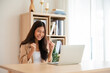 © Monster Ztudio - Happy euphoric young asian woman celebrating winning or getting ecommerce shopping offer on computer laptop. Excited happy girl winner looking at notebook celebrating success