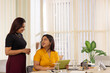 © IndiaPix - Two confident young businesswomen having a discussion while working together on a laptop in an office�