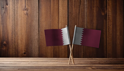 View of Qatar flag of the wooden table, copy space. Unaltered, national flag, patriotism, freedom and identity concept.