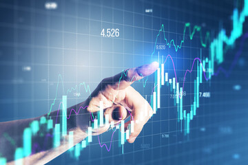 Wall Mural - Close up of male hand pointing at growing forex chart on blurry background. Financial investment and economy concept.