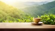 Tea cup with organic green tea leaf on the wooden table and the tea plantations background
